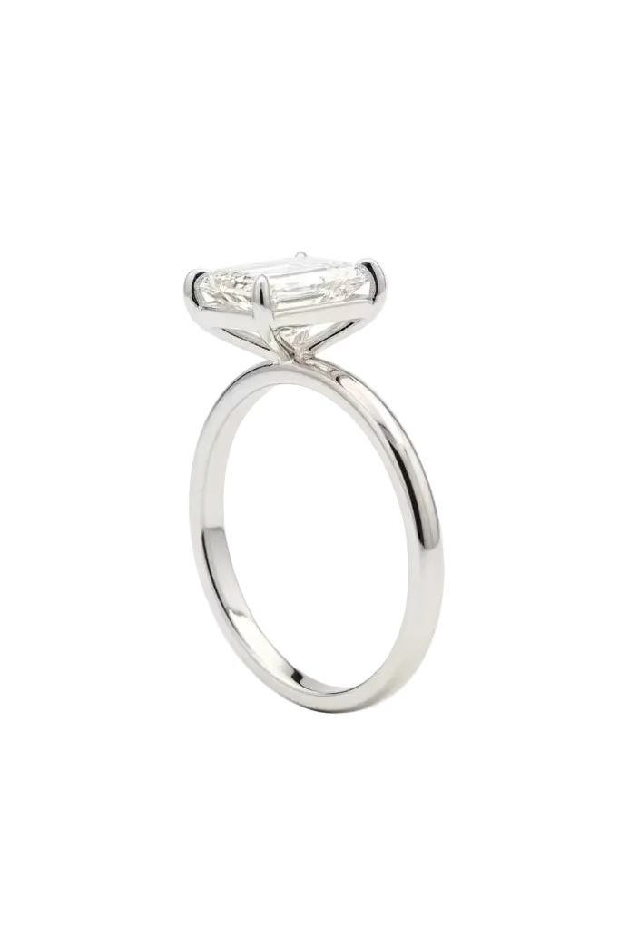 Silver ring with a diamond on a light gray background
