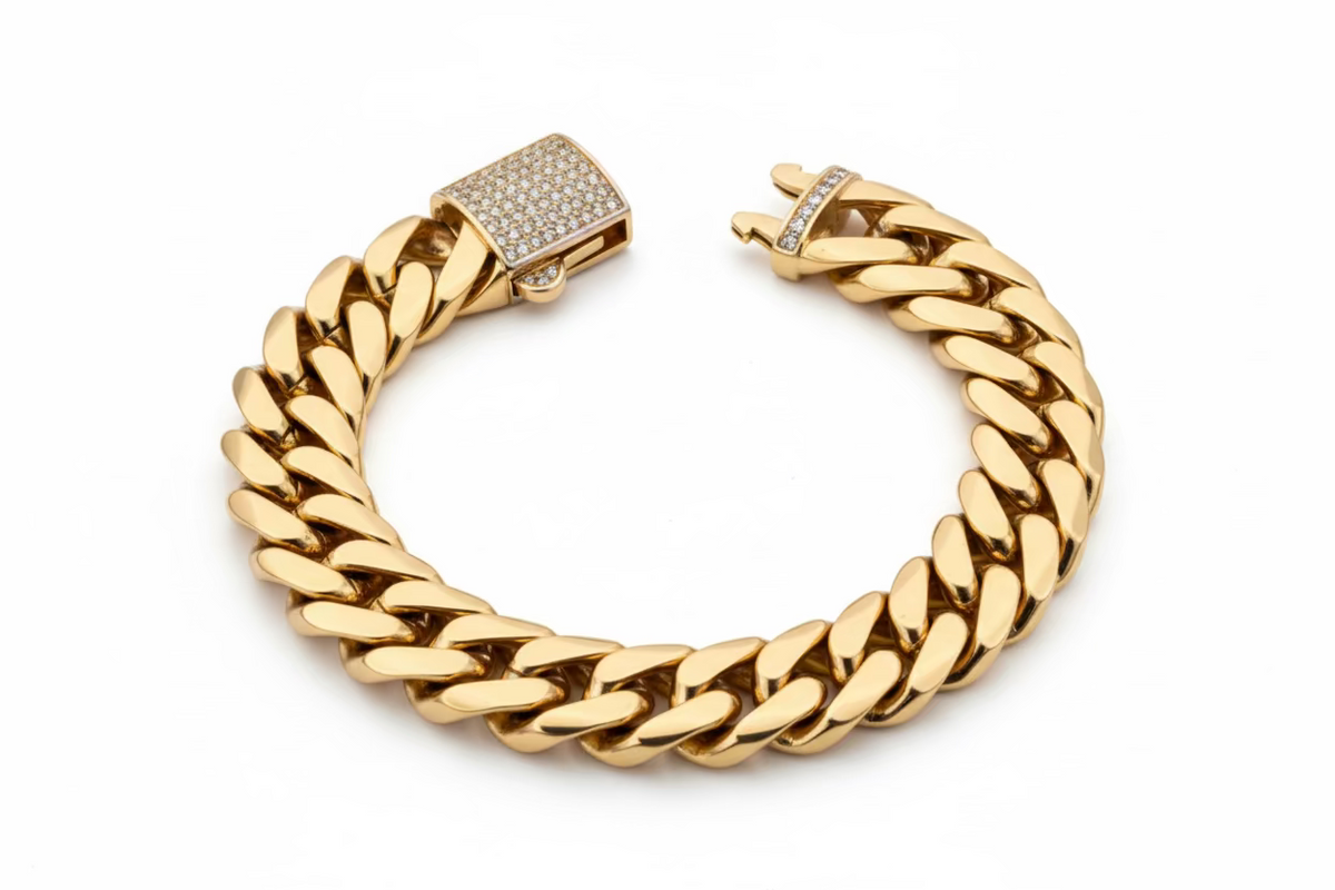 Gold chain bracelet with a clasp on a light gray background