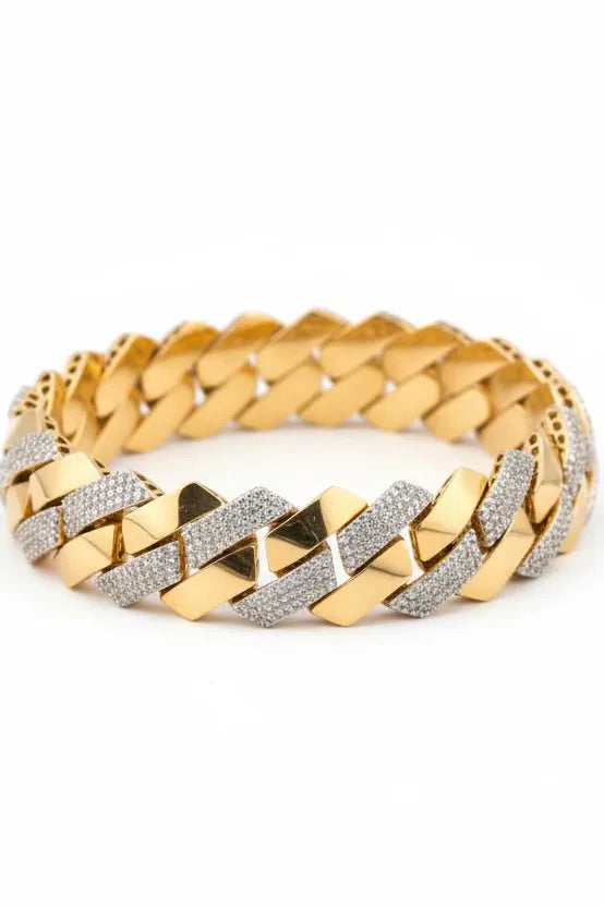 Gold bracelet with diamond accents on a piece of paper